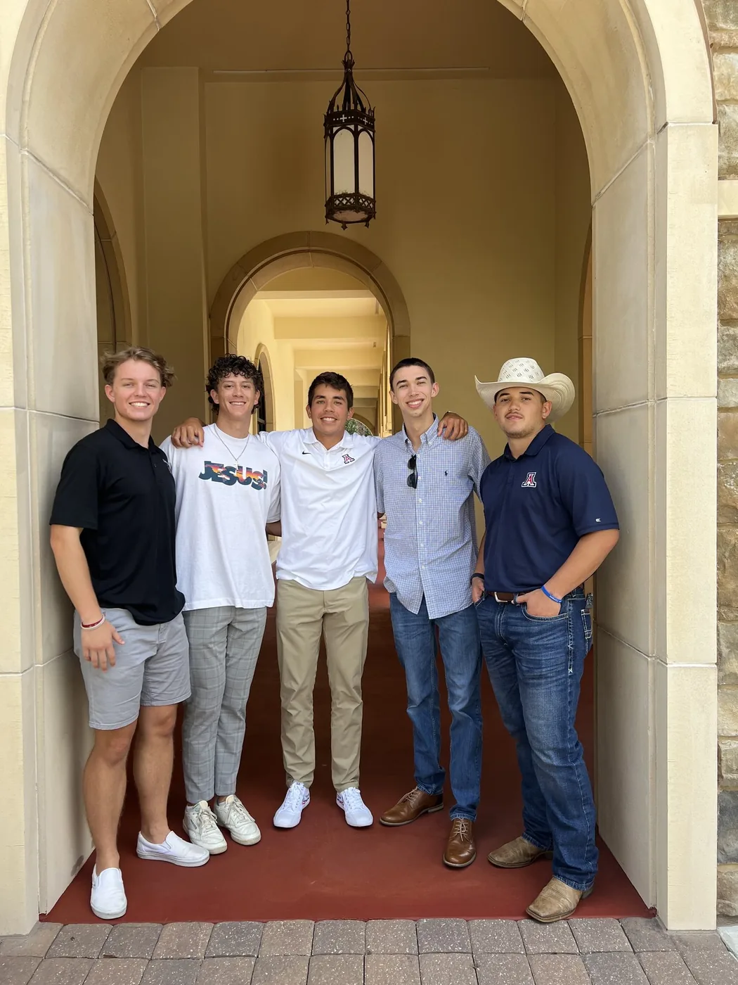 Noah with a group of guys in an archway