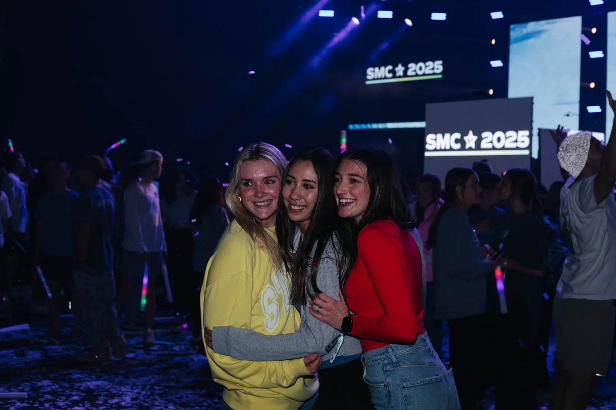 SMC Conference - three girls in front of the SMC 2025 sign