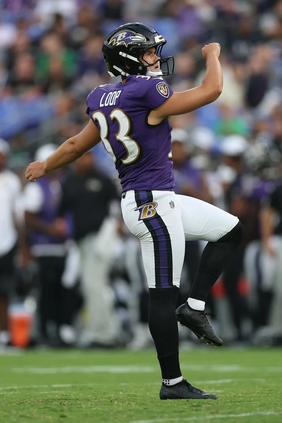Tyler Loop kicking for the Baltimore Ravens in his #33 jersey