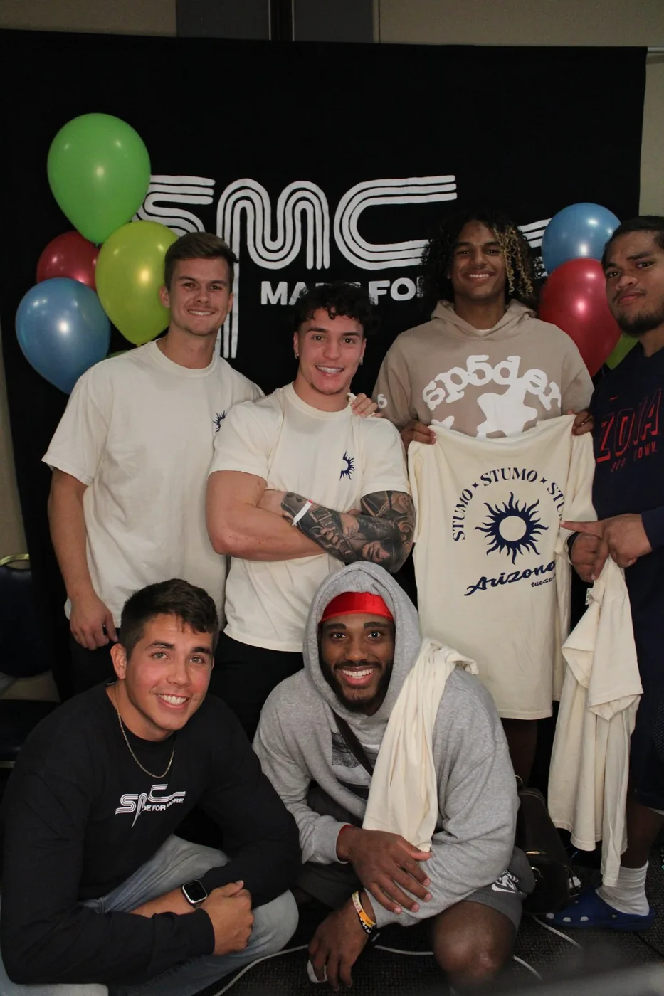 Tyler and friends in front of the SMC banner